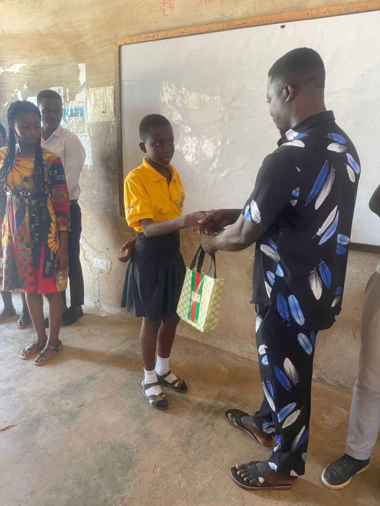 Access Smile Foundation presenting educational learning materials to students during the 2021 school support outreach program in Ghana.