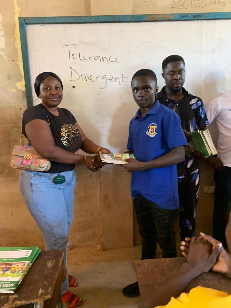 Access Smile Foundation presenting educational learning materials to students during the 2021 school support outreach program in Ghana.